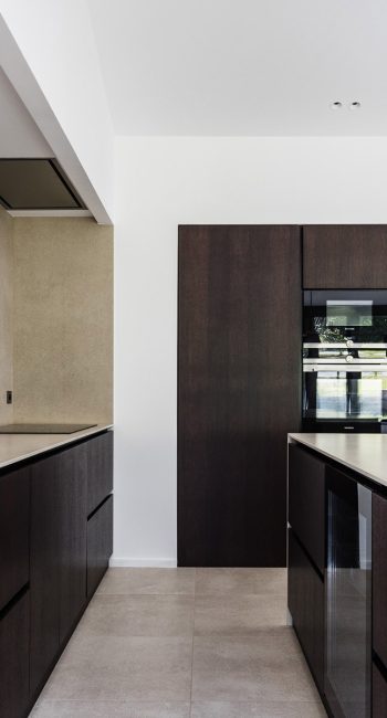 Cuisine en bois et en béton ciré. Idée pensée par le studio d'architecture d'intérieur Studio Naqaa.